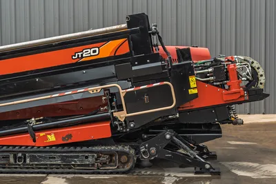 Side view of 2018 Ditch Witch JT20 HDD drill, showing carriage, tracks, engine housing, and hydraulic hose components.