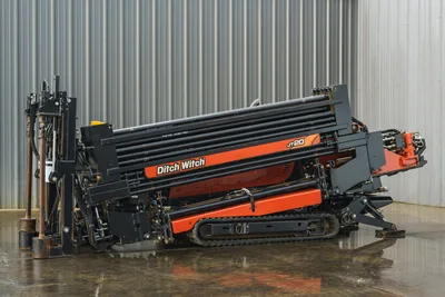 2015 Ditch Witch JT20 HDD drill tilted upright, showing drill pipe rack, rubber tracks, hydraulics, and anchor system
