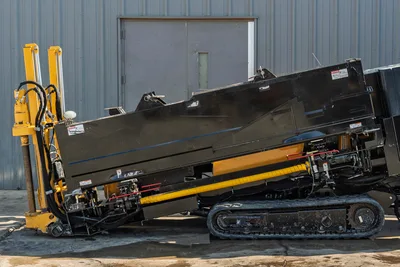 2016 Vermeer D23x30 S3 HDD drill, side view, yellow drill frame raised, rubber tracks, hydraulic lines, rack-and-pinion visible
