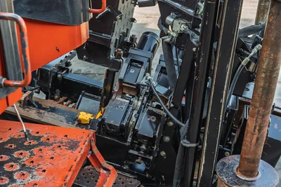 2021 Ditch Witch JT28 drill drive gearbox, hydraulic lines, carriage frame, and 2.375" drill pipe, overhead close-up view