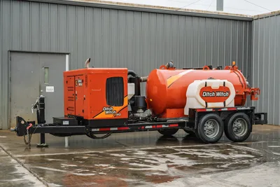 2021 Ditch Witch HX50 mud recycler on tandem-axle trailer, full side view showing engine enclosure, mixing tank, and vacuum tank