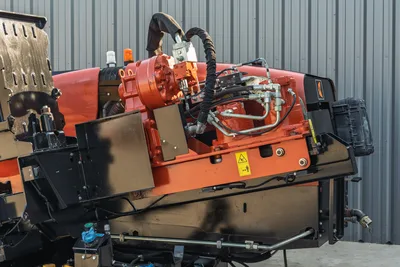 2021 Ditch Witch JT28 HDD drill head close-up showing red rotary drive, hydraulic hoses, fittings, and black carriage frame
