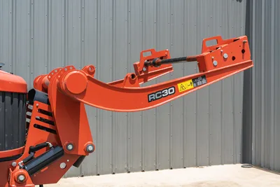 2024 Ditch Witch RT125Q RC30 boom arm close-up, orange hydraulic cylinder, pivot joints, safety decals, low hours