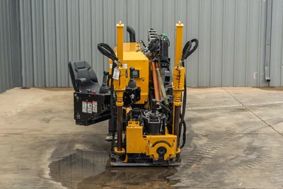 2018 Vermeer D8x12 HDD drill, rear view showing operator seat, joystick controls, drill pipe, hydraulic cylinders, and anchor system