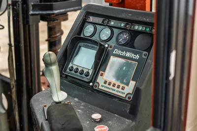 Ditch Witch JT3020 operator control console, display screens, gauges, and joystick inside the HDD drill rig cab.