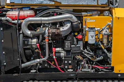 2021 Vermeer D8x12 engine compartment open, showing Kohler 48HP engine, exhaust, hydraulic oil filter, and hose routing