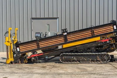 2009 Vermeer D36x50 Series II HDD rig side view, featuring drill pipe rack, steel tracks, and operator station.