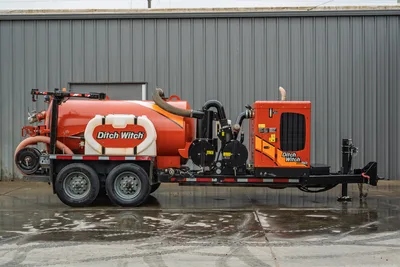 2021 Ditch Witch HX50 mud recycler, full driver-side profile, orange tank, hose reel, vacuum pump, engine enclosure, tandem axle trailer