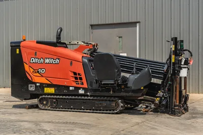 2018 Ditch Witch JT10 HDD drill, side profile view, tracked undercarriage, drill pipe rack, operator seat, clean condition.