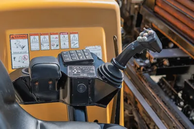 2020 Vermeer D24x40 S3 operator controls: joystick, function keypad, armrest, warning decals; drill pipe rack visible right
