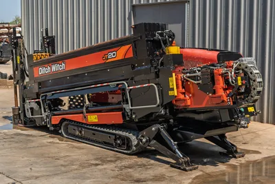 2022 Ditch Witch JT20 HDD drill, rear 3/4 view showing carriage, hydraulic system, anchor legs, rubber tracks, and chain drive