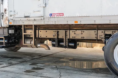 Side profile of 2000 Freightliner FL80 mud truck chassis, showing Morgan body, exhaust system, and air tank components.