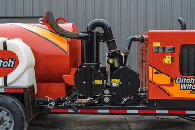 2019 Ditch Witch HX30 vacuum excavator side profile, red tank, filtration system, engine housing, and water storage tank.