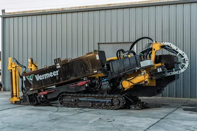 2019 Vermeer D40x55 S3 HDD drill angled upward, showing rubber tracks, carriage, hydraulic hoses, and pipe rack, driver-side view