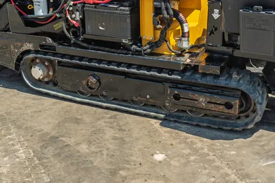 Vermeer 10x15 S3 HDD unit side profile showing tracked undercarriage, yellow drill head, engine compartment with radiator and hoses