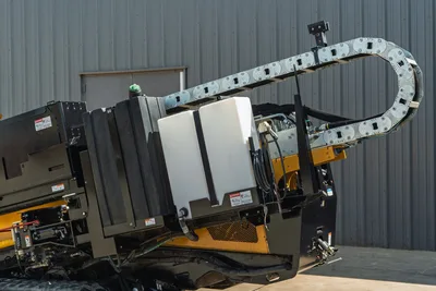 2022 Vermeer D23x30 S3 HDD drill carriage close-up showing cable track, white fluid tank, hydraulic hoses, yellow frame