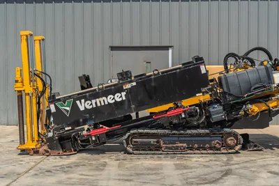 2020 Vermeer D24x40 S3 HDD drill, left-side view, angled drill frame raised, rubber tracks, hydraulic lines, fluid tank visible