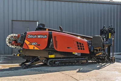2023 Ditch Witch JT20 horizontal directional drill, profile view showing tracks, engine compartment, and drill pipe rack.