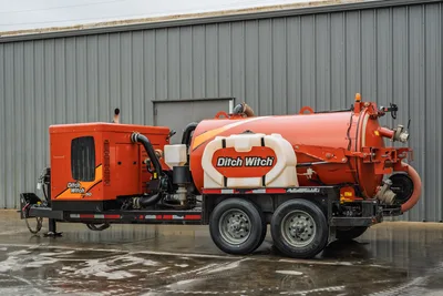 2021 Ditch Witch HX50 mud recycler, rear 3/4 view, tandem-axle trailer, orange vacuum tank, engine enclosure, hose connections visible
