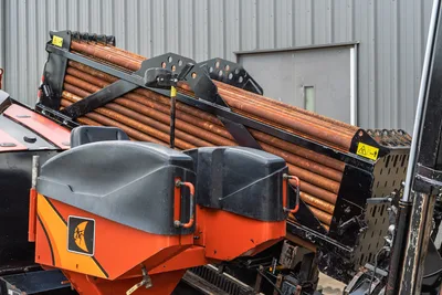 2021 Ditch Witch JT28 pipe rack loaded with used 2.375" drill pipe, orange carriage housing with Ditch Witch logo visible