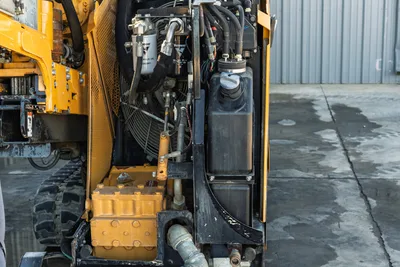2021 Vermeer D23x30 S3 HDD rig rear engine bay showing hydraulic oil filter, cooling fan, fluid reservoir, and mud pump
