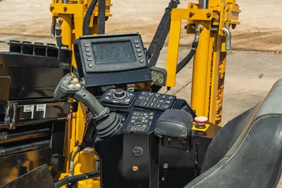 Vermeer D23x30 S3 operator console with LCD display, joystick controls, function keypad, e-stop button, and yellow drill frame