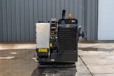 2018 Ditch Witch JT10 HDD rear view showing fluid tank, engine radiator, exhaust stack, warning light, hydraulic valves, and rubber tracks