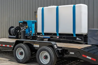 Behnke CBCT2324E-BT-R trailer with Straightline SL500 mud mixer, white poly tank, blue frame straps, hose reel, tandem axle, wood deck