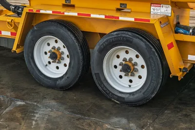 2021 TowMaster T-20D trailer tandem axle close-up showing 235/75R17.5 MasterTrack tires, white steel wheels, yellow frame