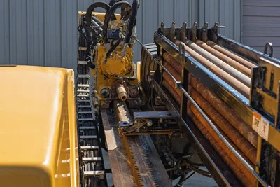 Vermeer D36x50 Series II carriage, rack and pinion drive system, and drill pipe rack with loaded drill rods.