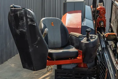 2020 Ditch Witch JT24 operator station, overhead view showing adjustable seat, control joystick, and drill carriage assembly.