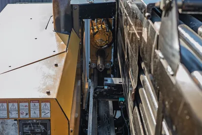 2016 Vermeer D23x30 S3 drill frame close-up showing spindle, thrust cylinders, rack-and-pinion carriage, and safety decals