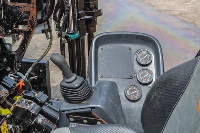 2018 Ditch Witch JT10 operator console showing joystick control, three analog gauges, and drill frame with hydraulic hoses
