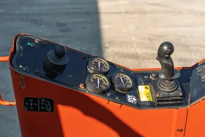 2021 Ditch Witch JT28 operator console, dual joysticks, three analog gauges, wear-worn black panel, orange housing, 811 decal