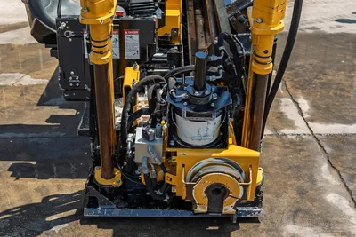 2021 Vermeer D8x12 HDD drill head closeup showing spindle, hydraulic rotary, vise assembly, and hydraulic lines