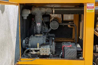 2024 Vermeer LP573SGT mud vacuum pump engine compartment featuring open access to the pump assembly, battery, and plumbing.