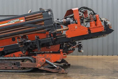Side profile of 2008 Ditch Witch JT4020 MACH 1 showing drill pipe rack, rotation carriage, tracks, and stabilizer legs.