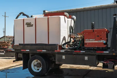 2015 International 7400 mud truck flatbed with Ditch Witch FM25 mixing unit, white poly tank, hydraulic hoses, side toolboxes, dual rear wheels
