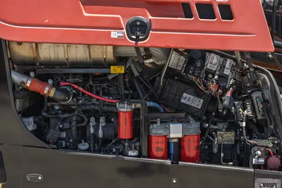2018 Ditch Witch JT30 All Terrain engine compartment, overhead view, showing Baldwin filters, hydraulic lines, wiring harness, and ECM modules.