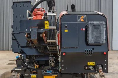 Rear view of 2021 Ditch Witch JT25 HDD drill, focusing on high-pressure hydraulic lines, engine cover, and torque drive.