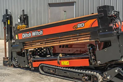 2021 Ditch Witch JT20 drill pipe rack and track carriage, side angle view showing main frame, boom, and drill string.