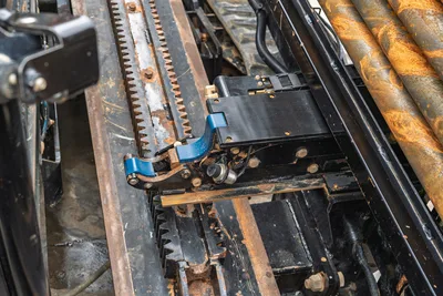 Ditch Witch AT40 drill rack and carriage assembly highlighting the thrust rack drive system and stored drill pipe segment.