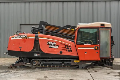 2012 Ditch Witch JT3020 Mach 1 side profile, rubber tracks, enclosed cab, engine housing, and drill pipe rack.