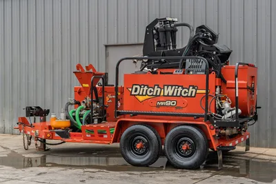 2015 Ditch Witch MR90 mud recycler, 3/4 rear view, tandem-axle trailer, mixing hopper, hydraulic hoses, pump manifold, green suction hose visible