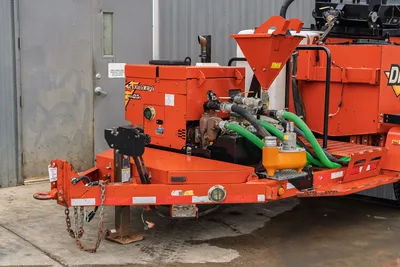 2015 Ditch Witch MR90 mud mixer trailer, front hitch angle, green suction hoses, orange hopper, pump unit, tongue jack visible