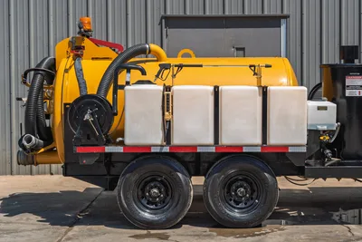 2025 Vermeer LP873SDT vacuum excavator trailer, side view showing yellow debris tank, hose reel, water tanks, and tandem axle