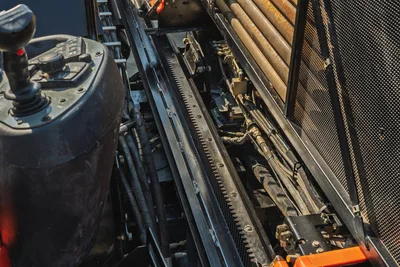2020 Ditch Witch JT24 operator station, rack and pinion drive, drill pipe rack, and hydraulic lines in top-down view.