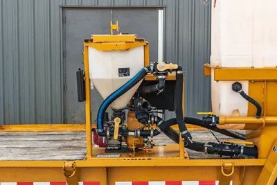 2021 TowMaster T-20D mud mixing hopper with pump, ball valves, and black hydraulic hoses on yellow trailer frame