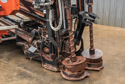 Ditch Witch JT4020 MACH 1 front view showing anchor drive system with dual augers, hydraulic components, and drill frame.