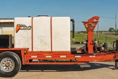 Belshe WB14-2EP trailer with Ditch Witch FM5 mixing system, orange frame, white Ditch Witch tank.